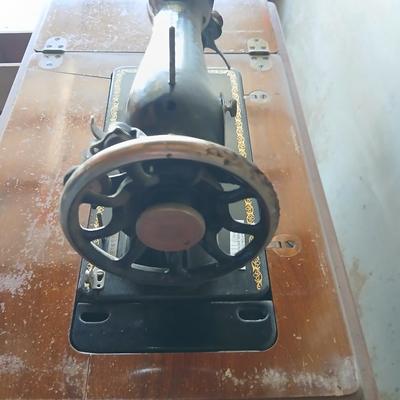 Vintage Singer treadle sewing machine with a wooden cabinet