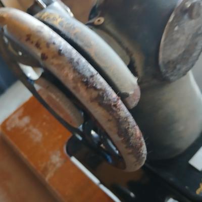 Vintage Singer treadle sewing machine with a wooden cabinet