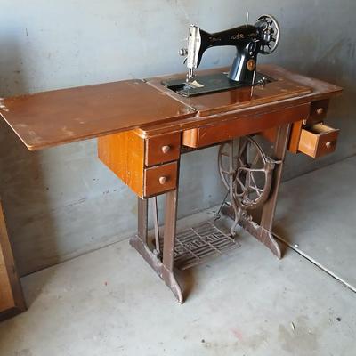 Vintage Singer treadle sewing machine with a wooden cabinet