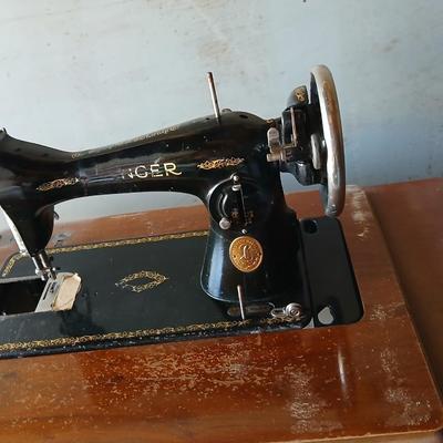 Vintage Singer treadle sewing machine with a wooden cabinet