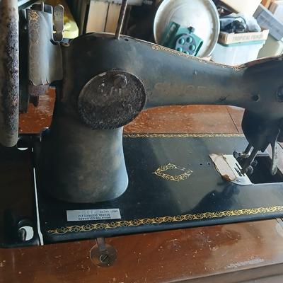 Vintage Singer treadle sewing machine with a wooden cabinet