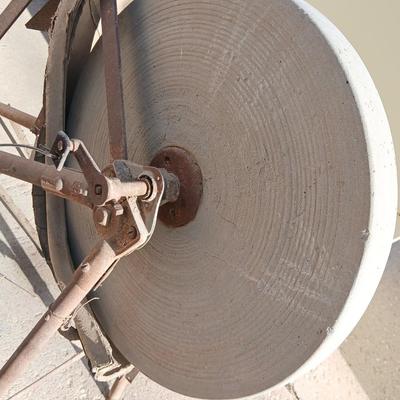 Antique foot-powered grindstone