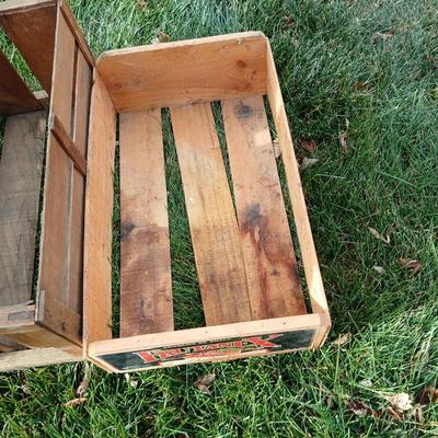 Two old wooden crateswith a round wood container