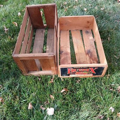 Two old wooden crateswith a round wood container