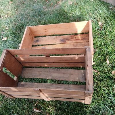 Two old wooden crateswith a round wood container