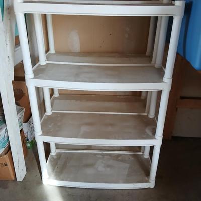 Two plastic storage shelves
