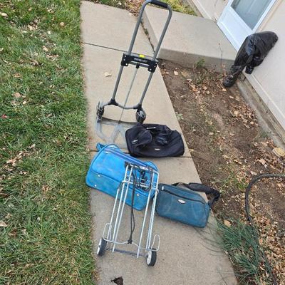 Two folding carts with assortment of luggage