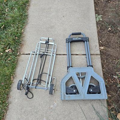 Two folding carts with assortment of luggage