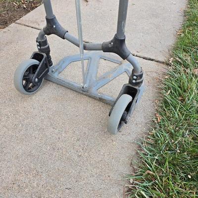 Two folding carts with assortment of luggage