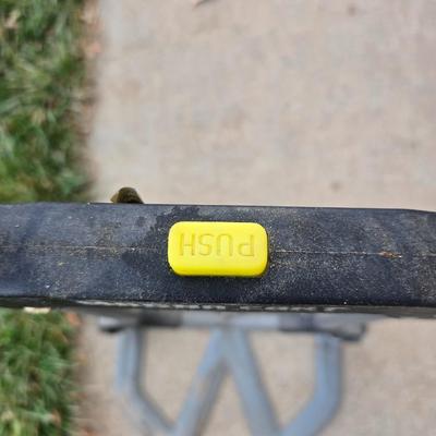 Two folding carts with assortment of luggage