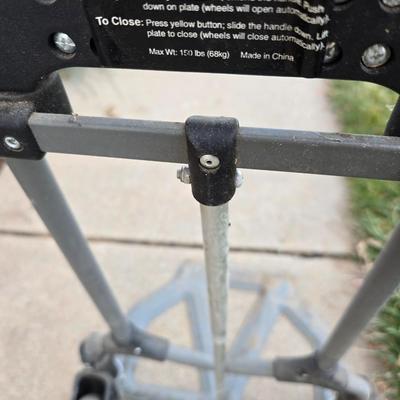 Two folding carts with assortment of luggage