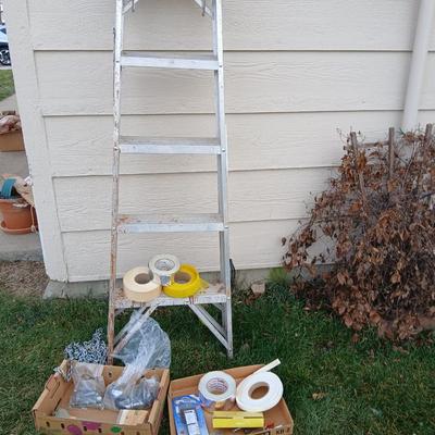 Ladder with an assortment of home repair items