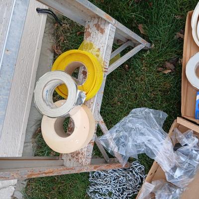 Ladder with an assortment of home repair items