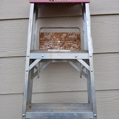 Ladder with an assortment of home repair items