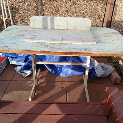 Metal framed foramina topped table with a marble countertop piece