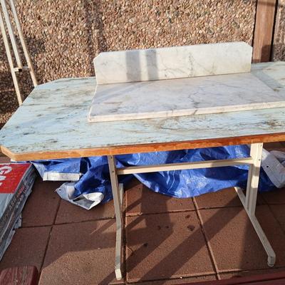 Metal framed foramina topped table with a marble countertop piece