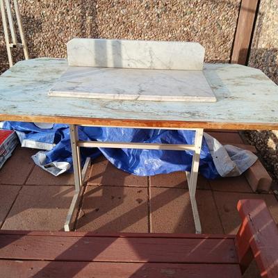 Metal framed foramina topped table with a marble countertop piece