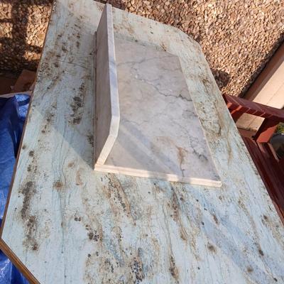 Metal framed foramina topped table with a marble countertop piece