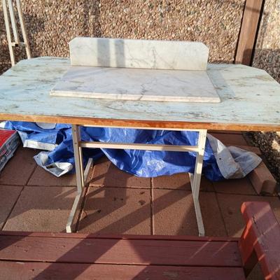 Metal framed foramina topped table with a marble countertop piece