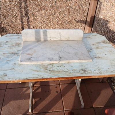 Metal framed foramina topped table with a marble countertop piece