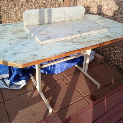 Metal framed foramina topped table with a marble countertop piece