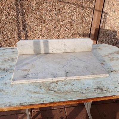 Metal framed foramina topped table with a marble countertop piece