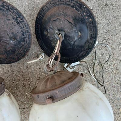 Two old lights with iridescent globes and a new stove pipe piece