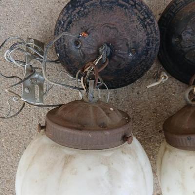 Two old lights with iridescent globes and a new stove pipe piece