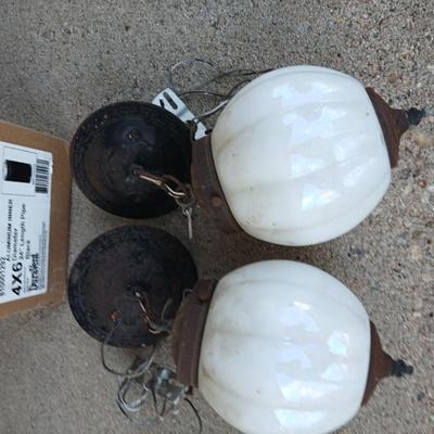 Two old lights with iridescent globes and a new stove pipe piece