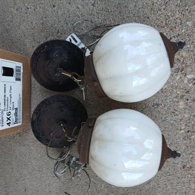 Two old lights with iridescent globes and a new stove pipe piece