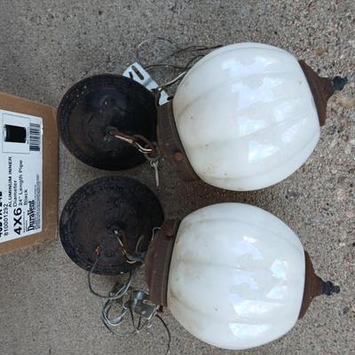 Two old lights with iridescent globes and a new stove pipe piece