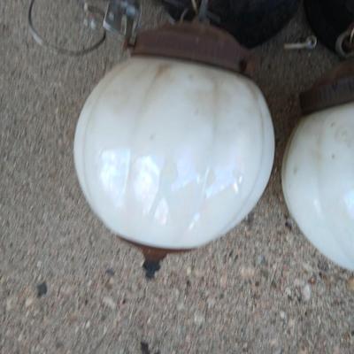 Two old lights with iridescent globes and a new stove pipe piece