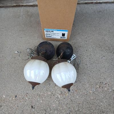 Two old lights with iridescent globes and a new stove pipe piece