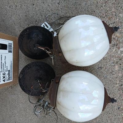 Two old lights with iridescent globes and a new stove pipe piece