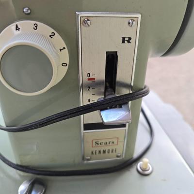 Vintage Sears Kenmore sewing machine with small tote of sewing supplies