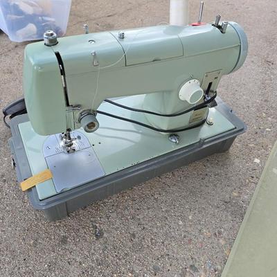 Vintage Sears Kenmore sewing machine with small tote of sewing supplies