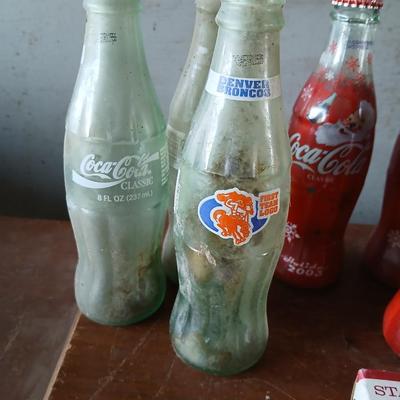 New CocaCola Starr bottle opener with a collection of glass Santa & Broncos coke bottles