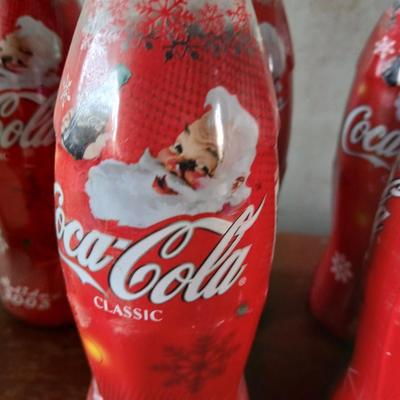New CocaCola Starr bottle opener with a collection of glass Santa & Broncos coke bottles
