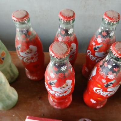 New CocaCola Starr bottle opener with a collection of glass Santa & Broncos coke bottles