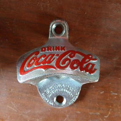 New CocaCola Starr bottle opener with a collection of glass Santa & Broncos coke bottles