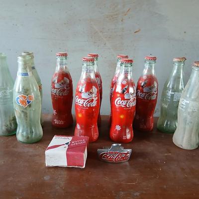 New CocaCola Starr bottle opener with a collection of glass Santa & Broncos coke bottles