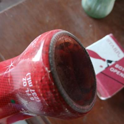 New CocaCola Starr bottle opener with a collection of glass Santa & Broncos coke bottles