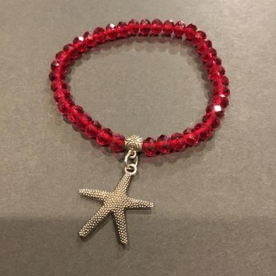 Beautiful, faceted, red crystal bead, stretch bracelet with charm