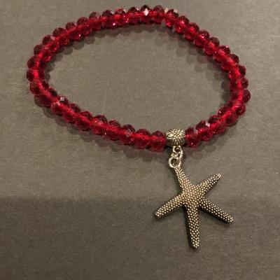 Beautiful, faceted, red crystal bead, stretch bracelet with charm