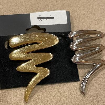 Gold and silver tone brooches