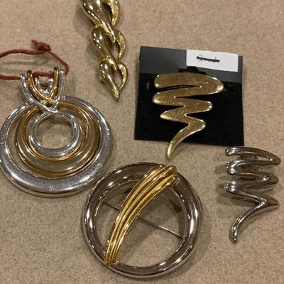 Gold and silver tone brooches
