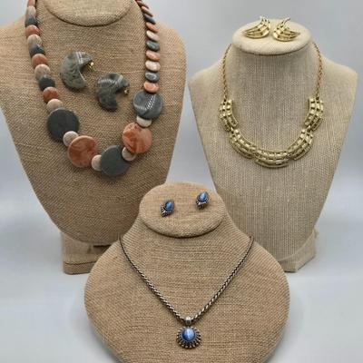LOT 52: Four Necklace and Earrings Sets