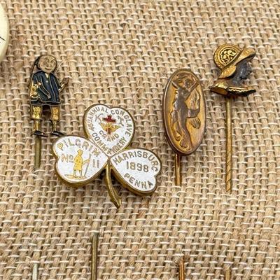 LOT 72: Collection of Stick Pins: Scrimshaw Style, Raggedy Ann, Four Leaf Clover & More