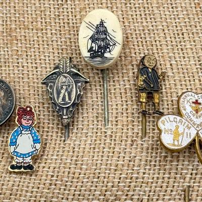 LOT 72: Collection of Stick Pins: Scrimshaw Style, Raggedy Ann, Four Leaf Clover & More