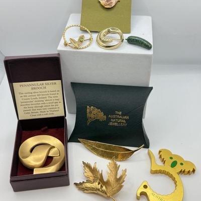 LOT 108: Australian Souvenirs, Heinz Pickle Pin, "Penannular Silver Brooch," Gold Plated Leaf Pins & More